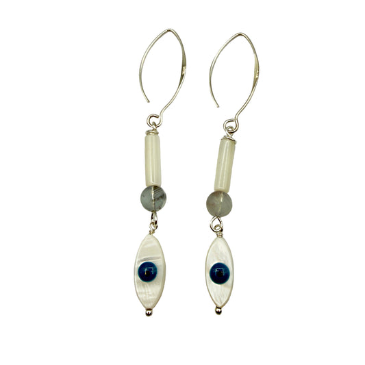 Pair of earrings with white beads, blue stones, and silver hooks on a light gray background