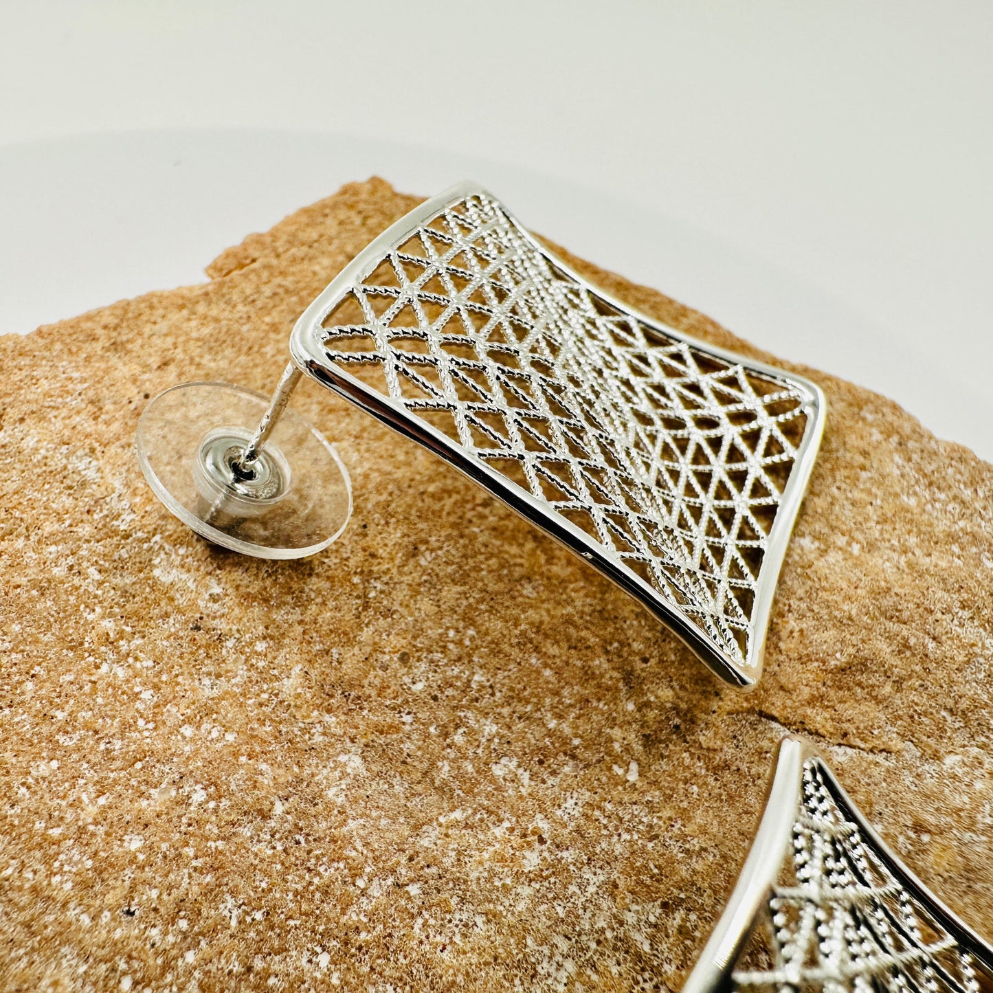 Close-up of intricate mesh pattern and polished metal surface