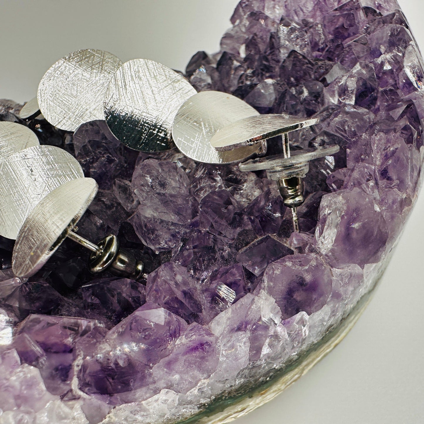 Side view showing depth and layering of polka dot dangle earrings