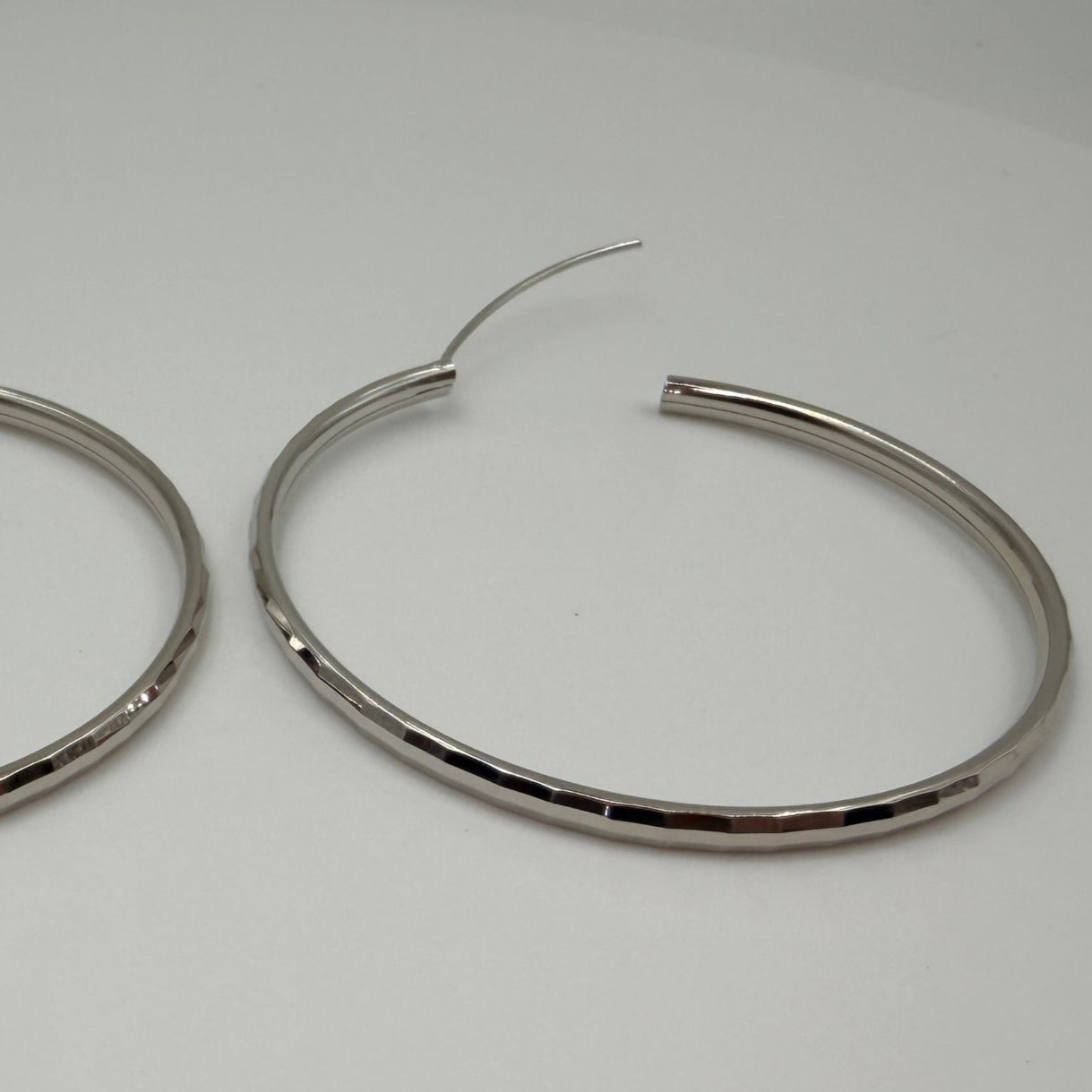 Side view showing depth and curvature of 50mm hoop earrings