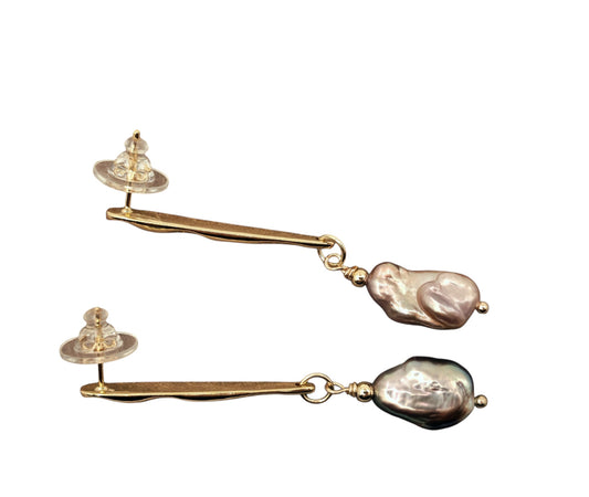 Side profile showing dangle and movement of gold-plated earrings