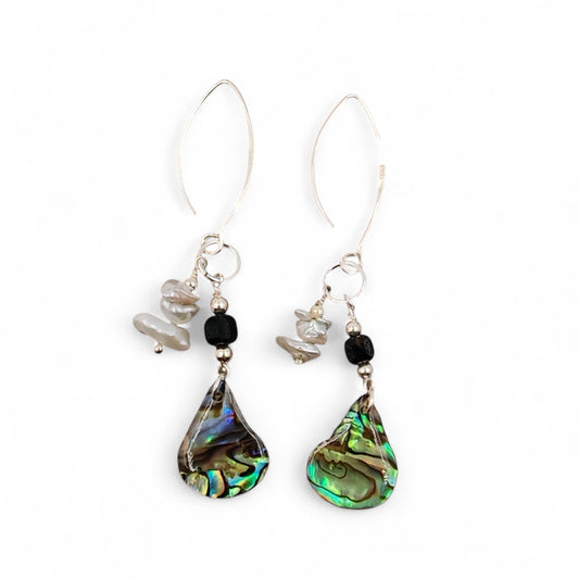 lose-up of baroque pearl, black ice obsidian, and iridescent abalone shell on silver chain