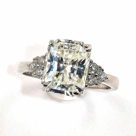 Close-up of princess-cut moissanite and pavé halo