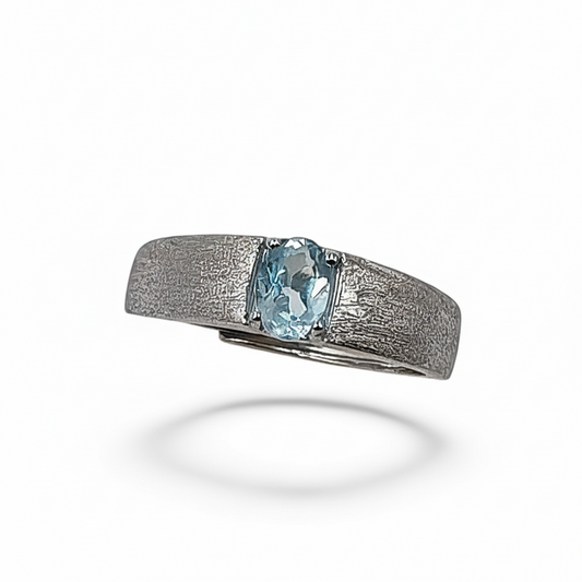 Silver ring with a blue gemstone on a white background