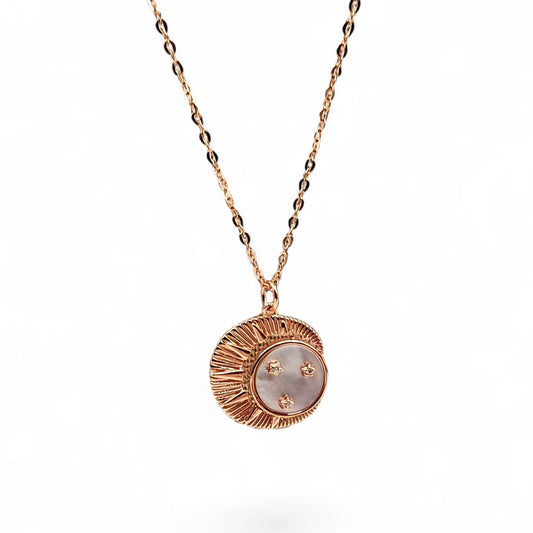 Close-up of crescent moon pendant with mother-of-pearl and zircon stars