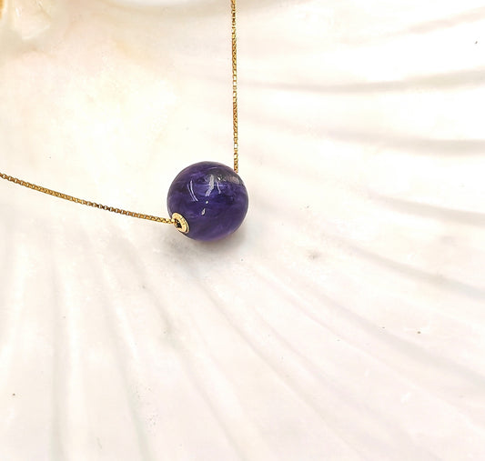 Close-up of charoite pendant and gold plating