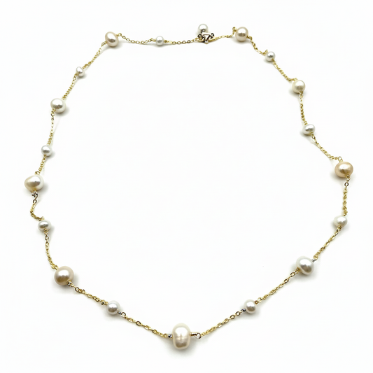 Pearl necklace with gold chain on a white background