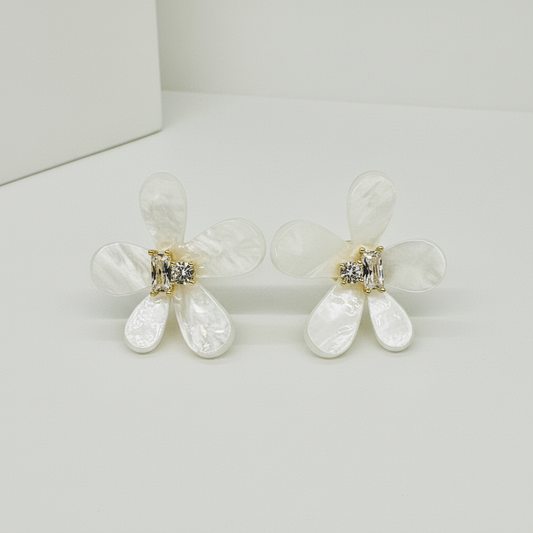 Close-up of marquise and round zirconia stones in gold-tone prong setting