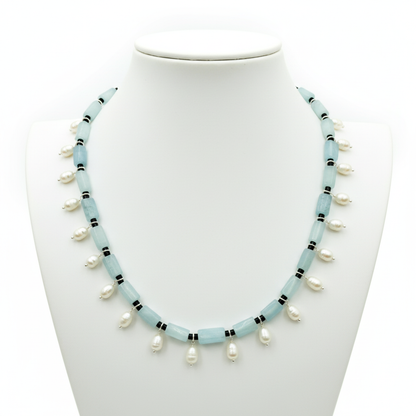 Necklace with light blue beads and white pearls on a mannequin.