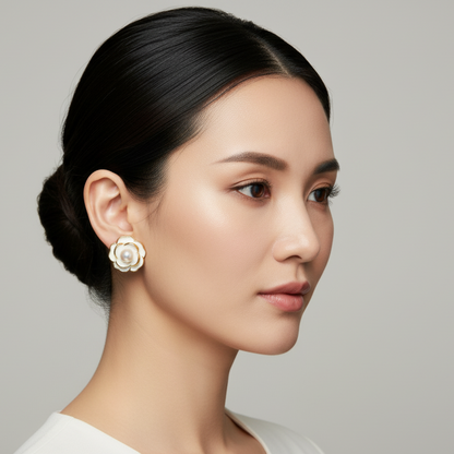 Woman wearing a floral earring against a neutral background