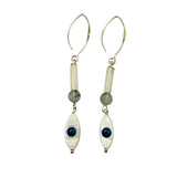 Pair of earrings with white beads, blue stones, and silver hooks on a light gray background