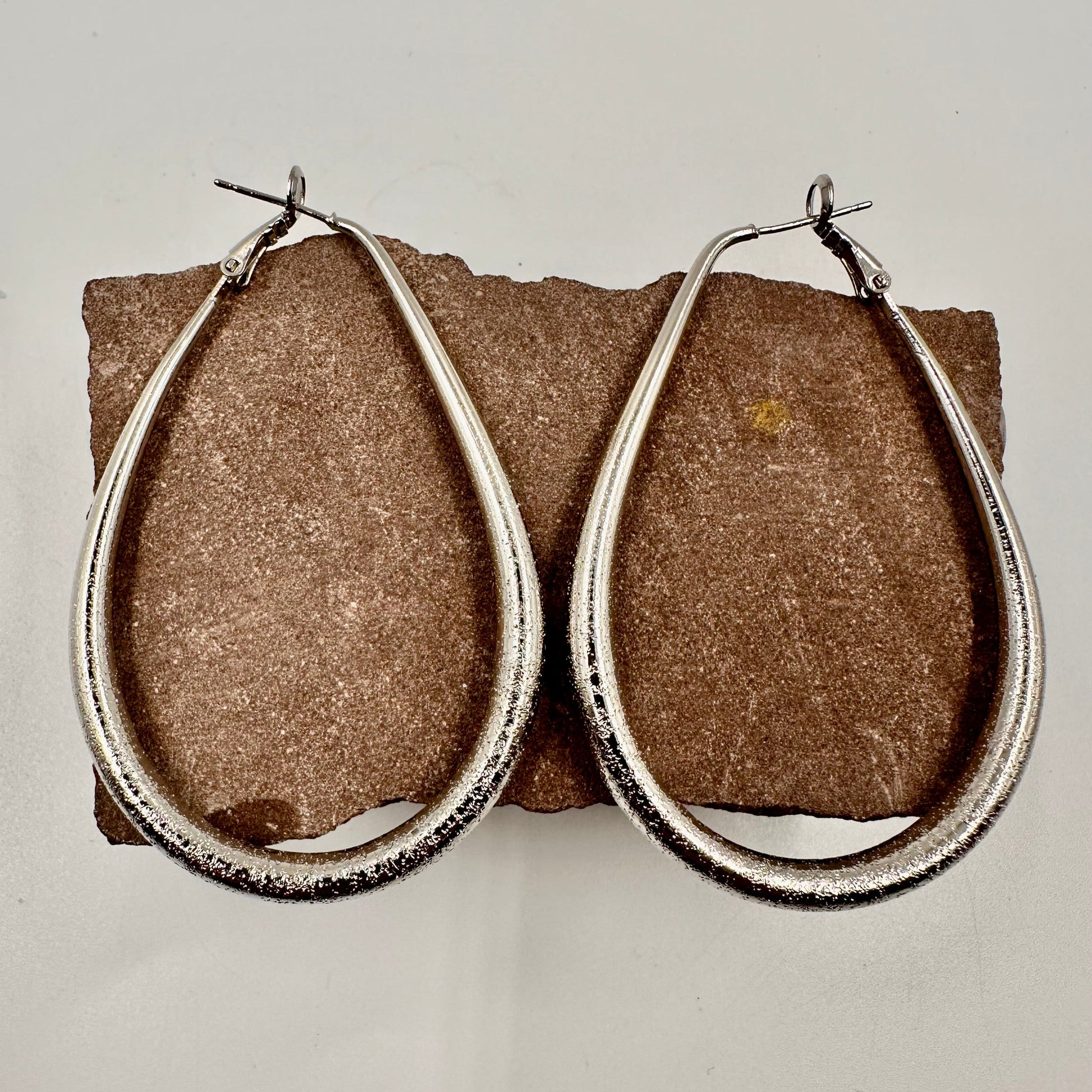 silver plated hammered teardrop hoops