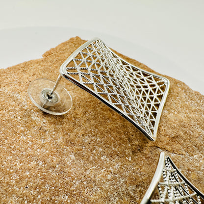 Close-up of intricate mesh pattern and polished metal surface