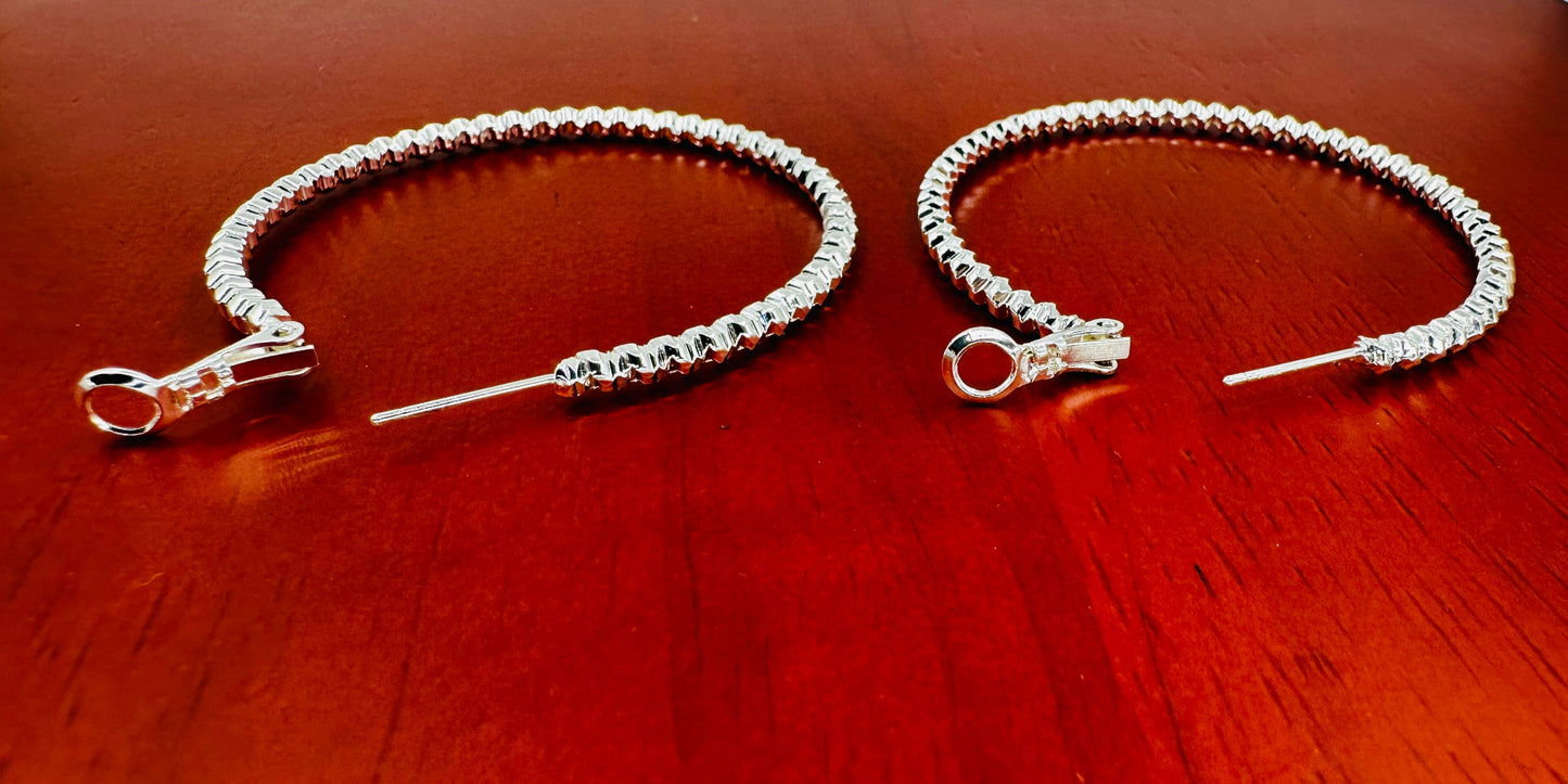 Side view showing depth and curvature of woven hoop earrings
