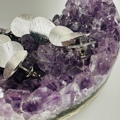 Side view showing depth and layering of polka dot dangle earrings
