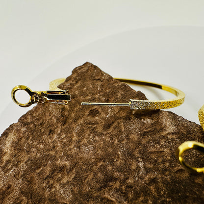 Side view showing depth and curvature of 45mm hoop earrings