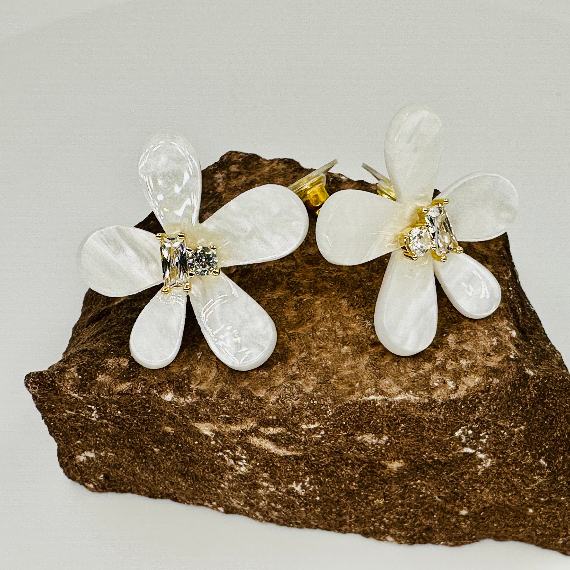 Close-up of marquise and round zirconia stones in gold-tone prong setting