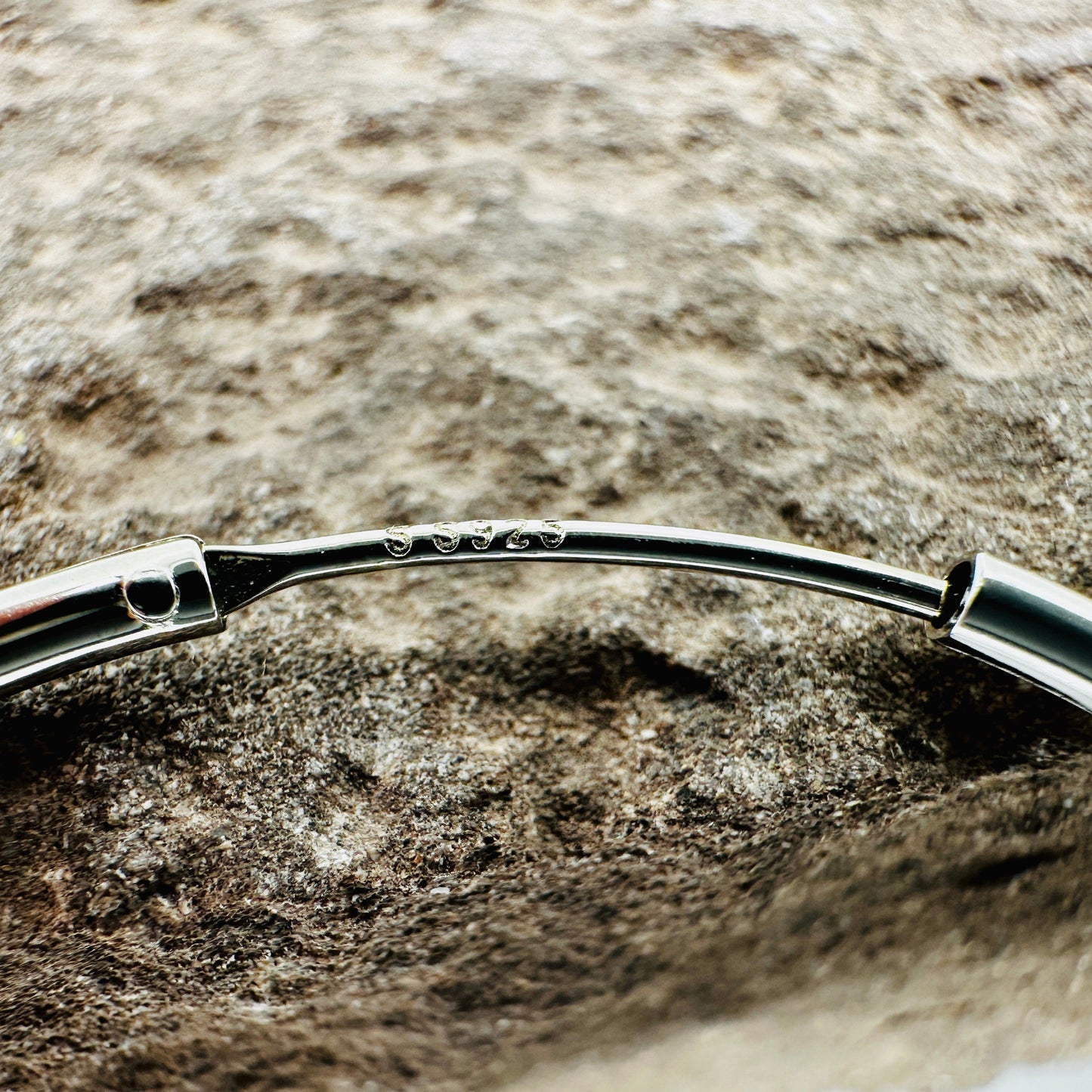 Close-up of polished surface and endless closure on 50mm silver hoop earrings