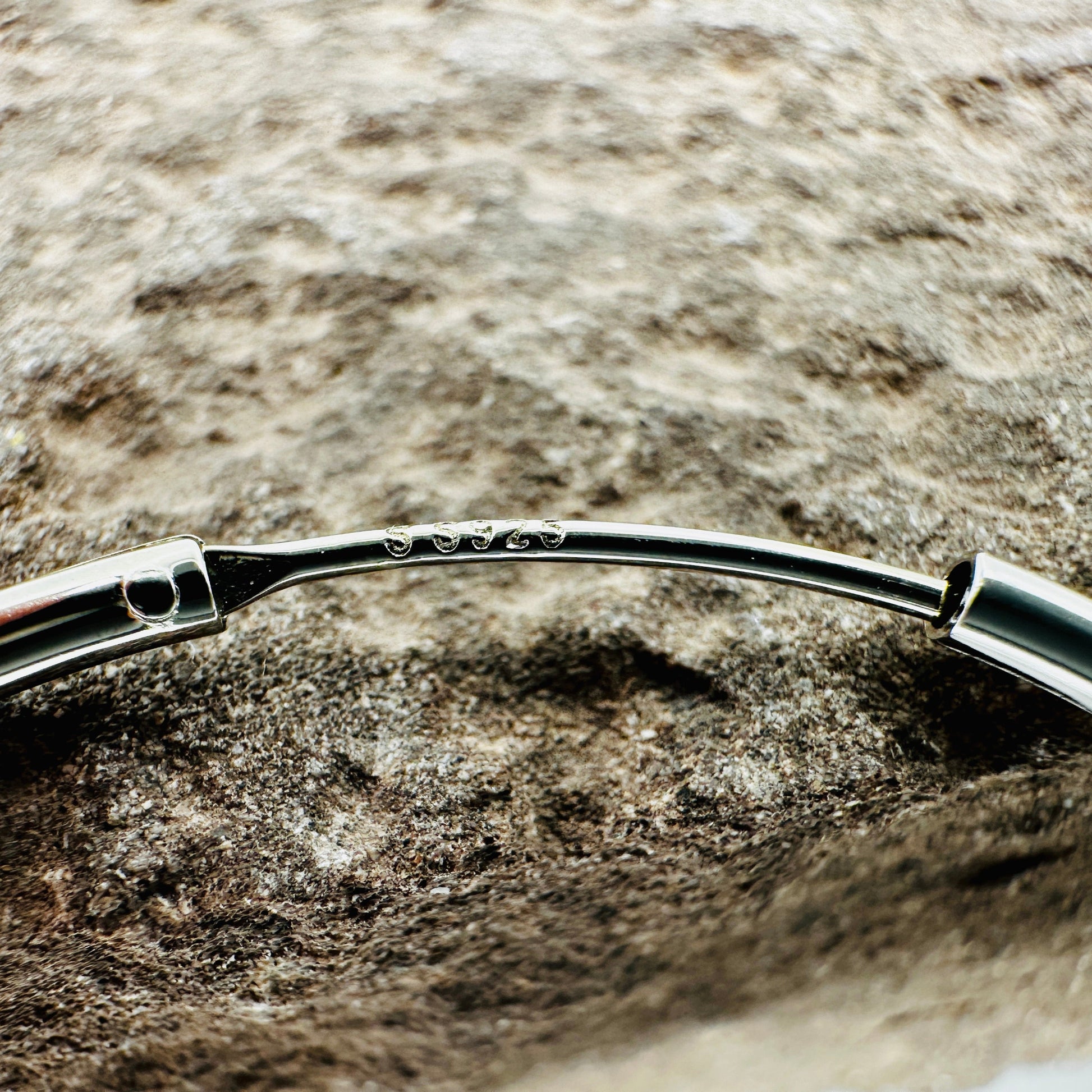 Close-up of polished surface and endless closure on 50mm silver hoop earrings