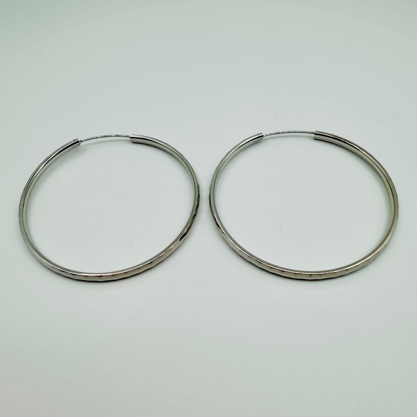 50mm sterling silver hammered hoop earrings with high-polish finish