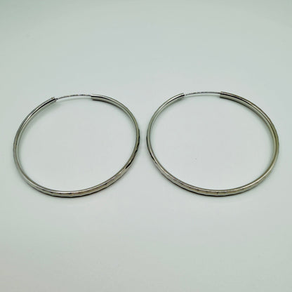 50mm sterling silver hammered hoop earrings with high-polish finish