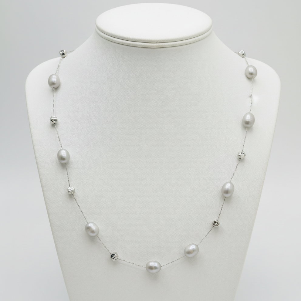 Pearl necklace on a mannequin bust against a white background