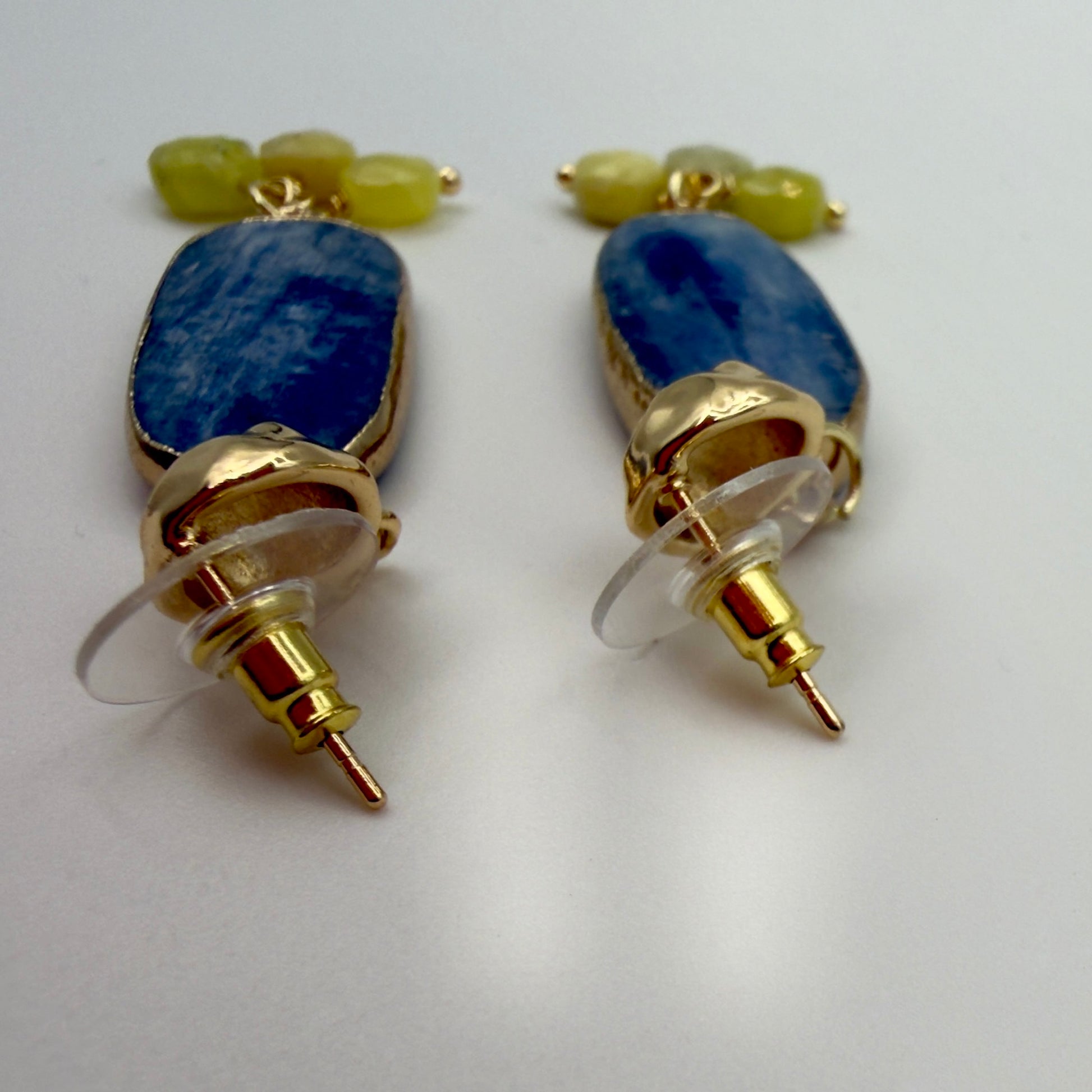 Close-up of the kyanite gemstone on the earring, highlighting its natural blue color and elongated shape.