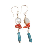 Close-up of white shell, red coral, and blue agate on silver chain