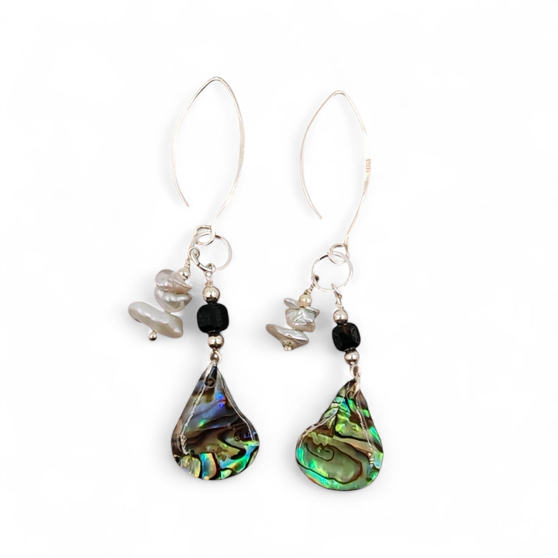 lose-up of baroque pearl, black ice obsidian, and iridescent abalone shell on silver chain