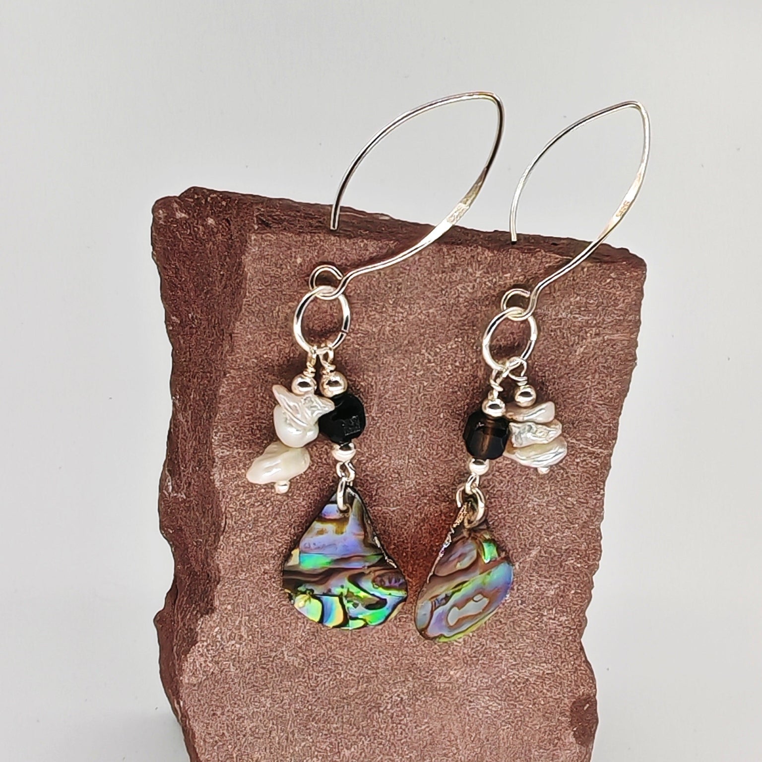 Sterling silver dangle earrings with white baroque pearl, black ice obsidian, and abalone shell