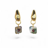 Close-up of square-cut green agate with centred ruby red garnet