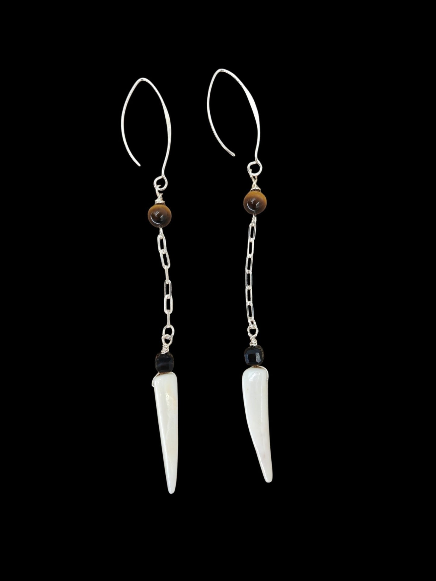 Close-up of tiger eye, black agate, and shell tiger tooth bead