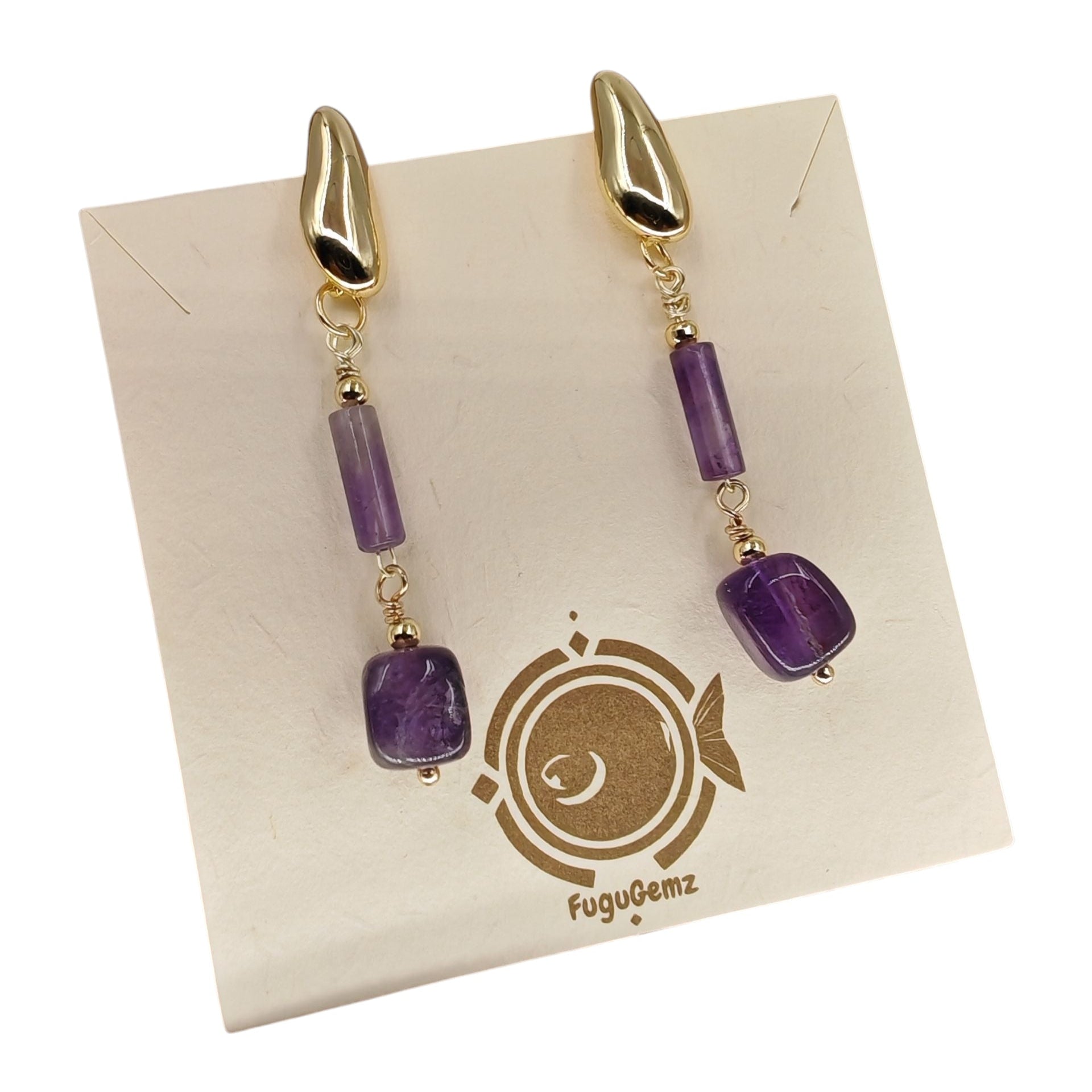 Pair of gold and amethyst earrings on a FuguGemz branded card.