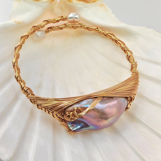 Brass wire-wrapped bracelet with large baroque centre pearl and two small baroque side pearls
