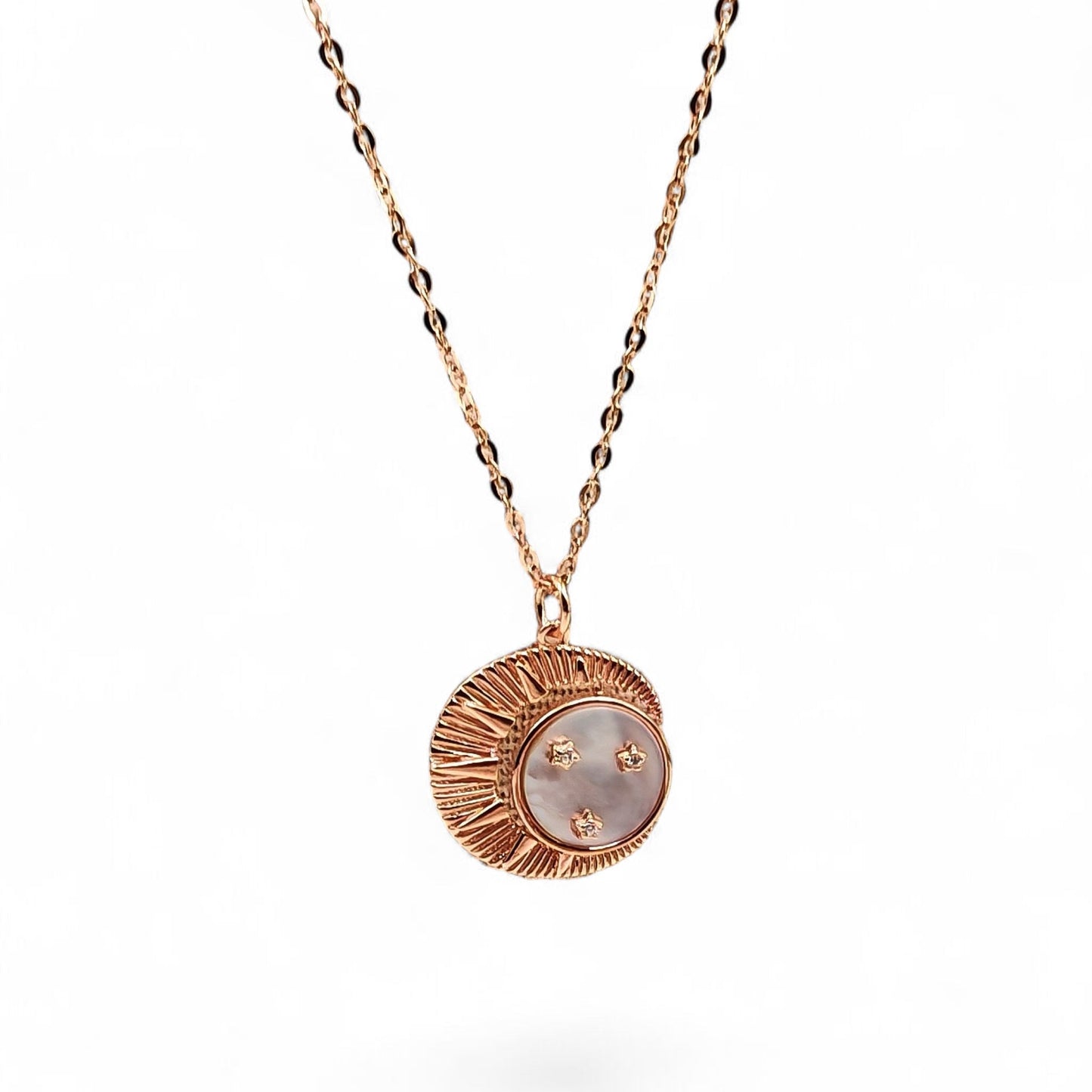 Close-up of crescent moon pendant with mother-of-pearl and zircon stars