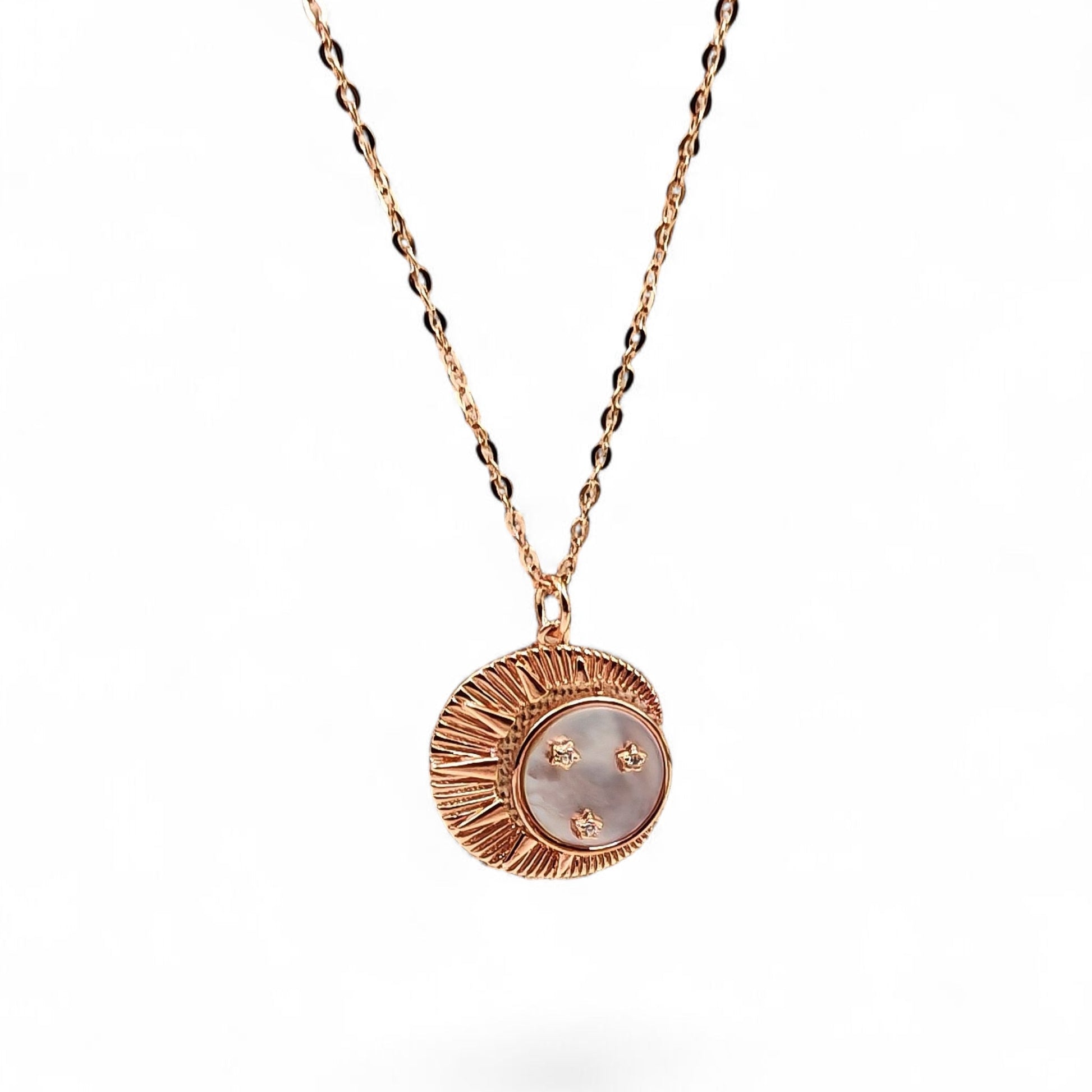 Close-up of crescent moon pendant with mother-of-pearl and zircon stars