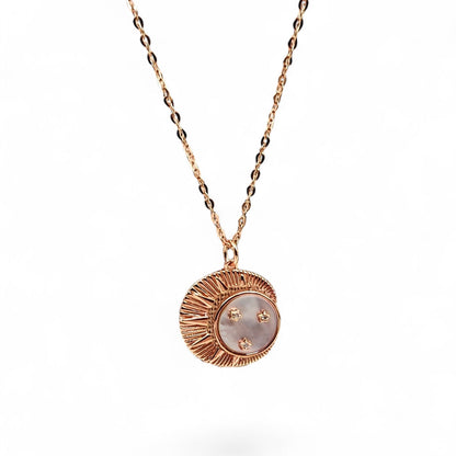 Close-up of crescent moon pendant with mother-of-pearl and zircon stars