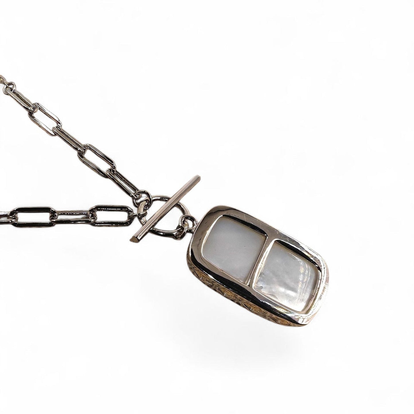 Close-up of rectangular pendant and silver casement
