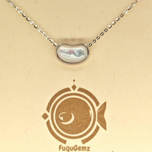 Close-up of kidney-shaped pendant and silver casement