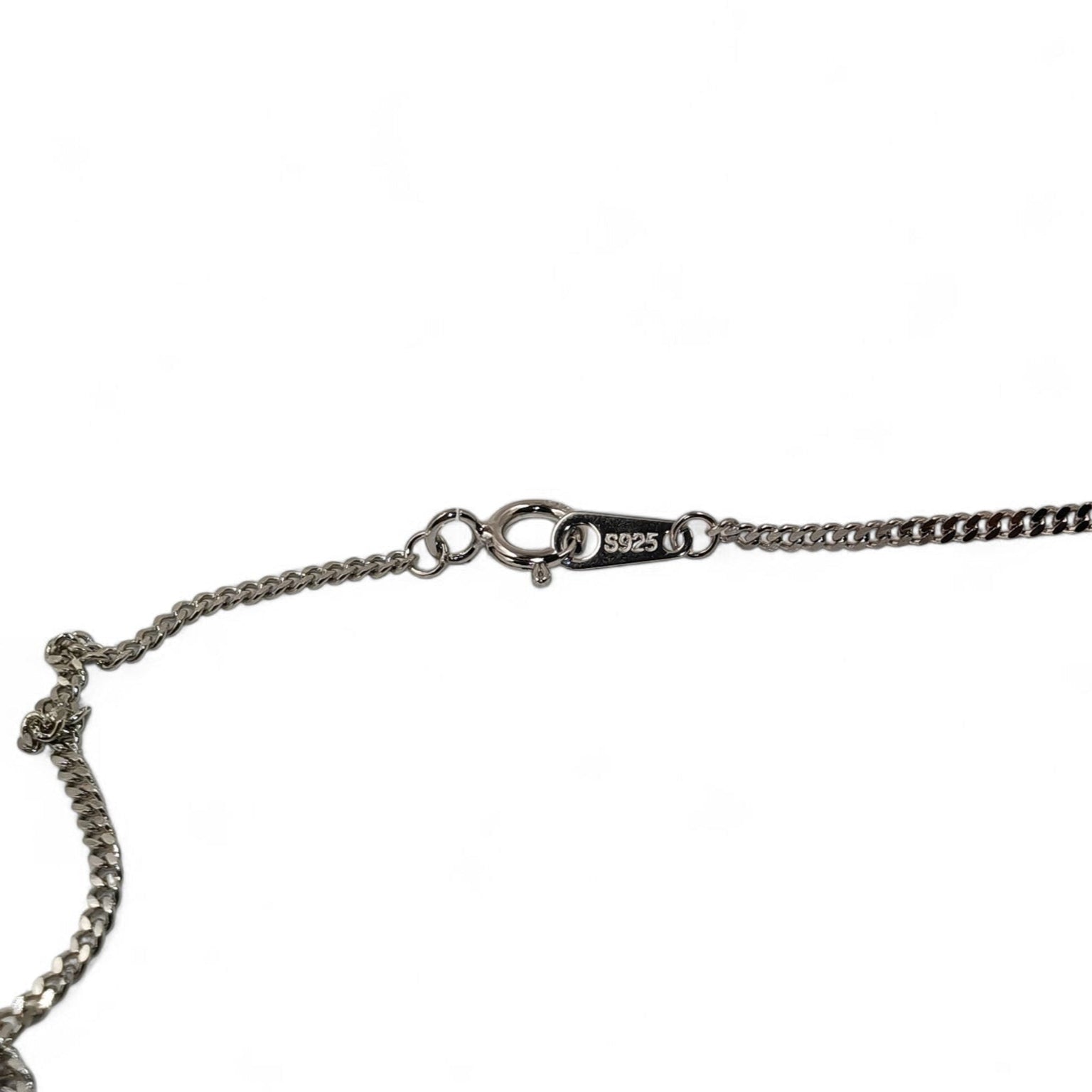 Close-up of a silver chain necklace with 925 stamp
