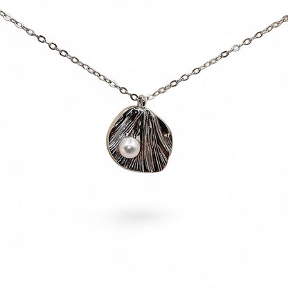 Close-up of textured silver leaf and pearl