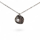 Close-up of textured silver leaf and pearl