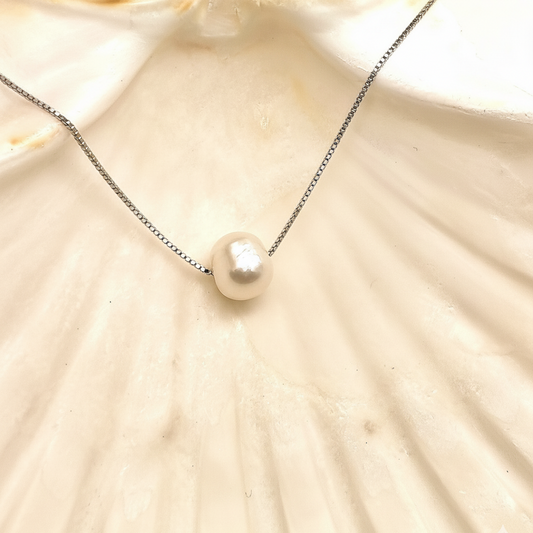 Close-up of pearl and silver chain