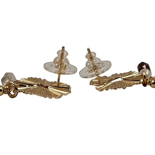 Gold and pearl earring on a white background