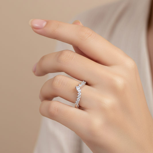 Hand wearing a moissanite eternity ring on a beige background