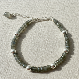 17cm labradorite bracelet with 42x4.5mm faceted beads and 6x5.8mm 925 plated beads on beige background