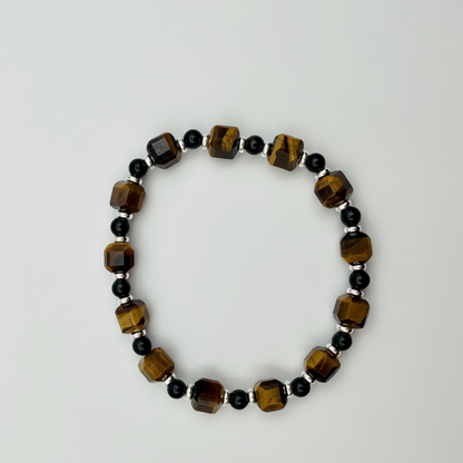 A 15cm stretch bracelet with tiger eye cubes, gold obsidian beads, and silver-plated disc accents.