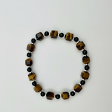 A 15cm stretch bracelet with tiger eye cubes, gold obsidian beads, and silver-plated disc accents.