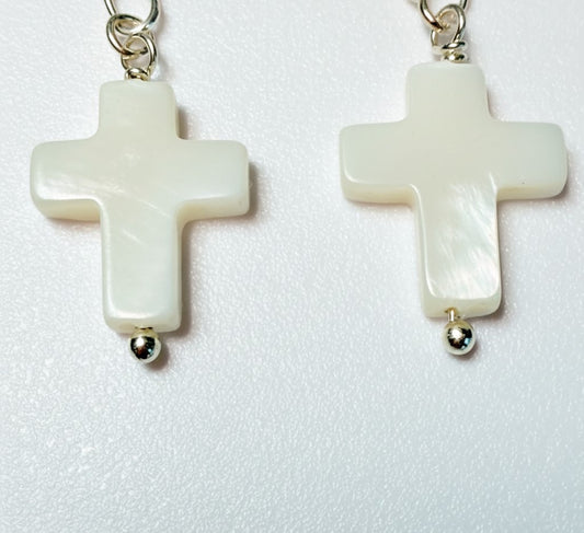 Image showing the full drop and the polished finish of the pearl cross earring.