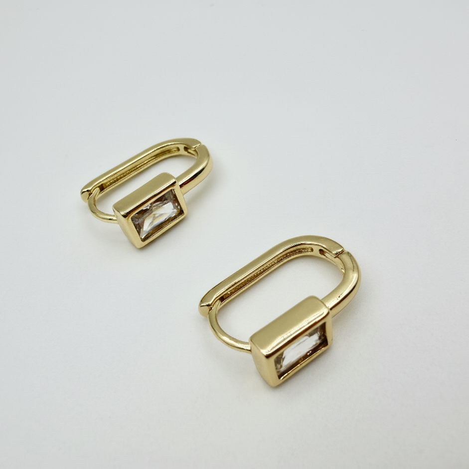 Close-up of a brilliant 7mm cubic zirconia stud earring set in 14K gold-plated silver.